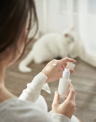 a woman holding cosmetics in a sunny space