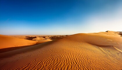 Naklejka premium A serene desert landscape with golden sand dunes under a clear blue sky.