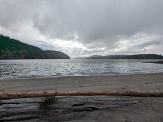 A dark and brooding sky above Active Pass viewed from a beach on Galiano Island BC Canada