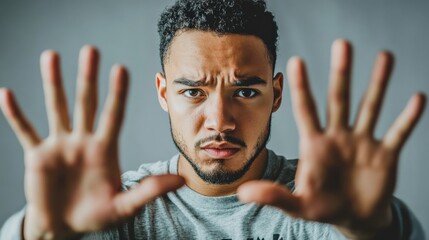 A stern-faced man firmly says “NO” while emphasizing rejection with strong hand gestures. His serious facial expression and assertive body language convey determination and refusal.