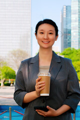 Confident Businesswoman Enjoying Coffee in a Modern Urban Setting