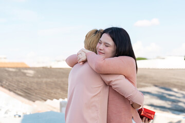 Couple embracing on rooftop valentine day surprise intimate setting joyful moment