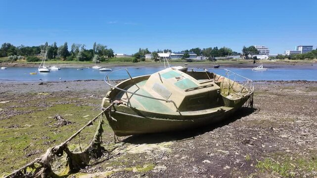 Old small boat moored in a reservoir with low water level