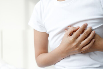 woman having chest pain while exercising - heart attack. or Heavy exercise causes the body to shock heart disease. may cause life-threatening. health care concept.