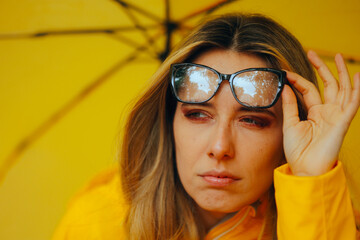 Woman Removing her Glasses in a Rainy-Day Squinting. Confused lady trying to figure out something...