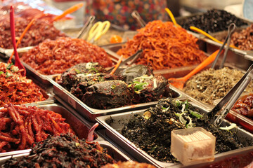 Fototapeta premium Variety of Spicy Korean Side Dishes, Salads and Fermented Foods in a Traditional Market Display in South Korea