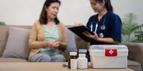 Caregiver consults elderly patient home setting medical guidance warm atmosphere compassionate approach