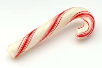 Fototapeta premium A classic red and white candy cane isolated on a white background, a festive treat.