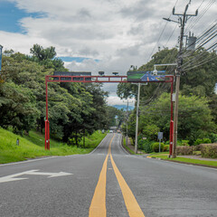 Empty asphalt road with green fields either side