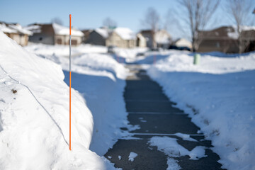 Sidewalk with edge markers used for snow blowing guides
