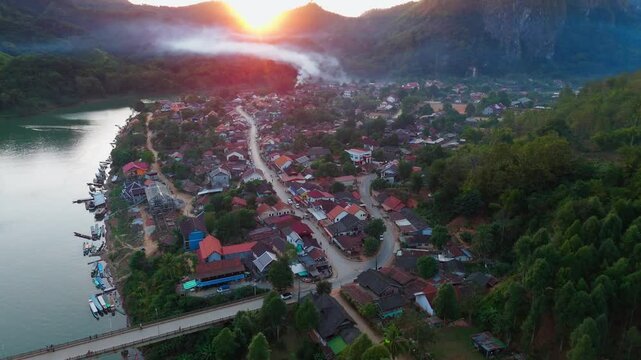 aerial sunset view of Nong Khiaw village in the Luang Prabang Province of northern Laos on the Nam Ou River drone footage travel destination south east Asia 