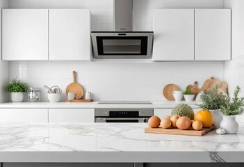 Modern white kitchen with clean lines and minimalist design, featuring a marble countertop with a wooden cutting board holding fresh tomatoes and kiwis. A black range hood adds contrast.