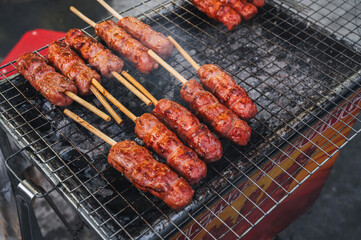 Pork sausage, cooked on a barbecue grill. Street food