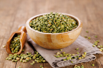 green split peas on wood background