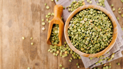 green split peas on wood background