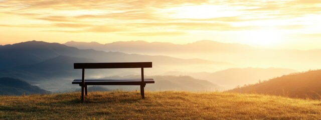 A serene empty wooden bench overlooking a breathtaking mountain landscape during a vibrant sunrise with misty valleys