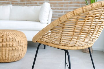 Fototapeta premium Cozy Woven Chair and Round Coffee Table in Modern Living Room Interior Design