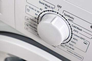 Circle selector for choosing the washing mode. Selective focus.