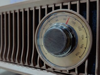 A classic radio exudes vintage charm with its retro design and analog dials.