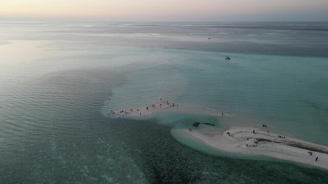 A stunning aerial view of Thulusdhoo Island, Maldives, showcasing turquoise waters, lush greenery, surf breaks, and vibrant local life, perfect for surfers, snorkelers, and tropical travelers