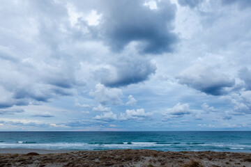 Mediterranean sea on stormy weather in Sardinia, Italy. Sardinian coast with cloudy sky.