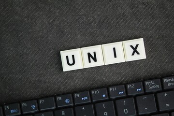 laptop keyboard with the word unix. an operating system analogous to DOS and Windows, supporting multiple concurrent users