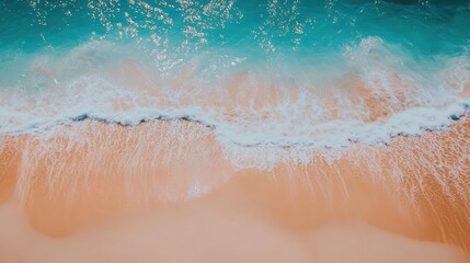 Fototapeta premium Aerial View of Clear Ocean Waves Gently Rolling onto Sandy Beach Shoreline