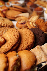 Assorted cookies displayed in a cozy bakery setting during a sunny afternoon
