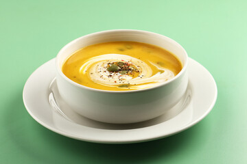 Pumpkin traditional soup with creamy silky texture garnished with pumpkin seeds 