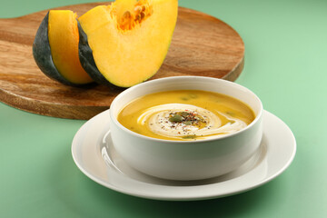 Pumpkin traditional soup with creamy silky texture garnished with pumpkin seeds 