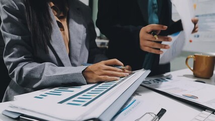 Two business leaders talk about charts, financial graphs showing results are analyzing and calculating planning strategies, business success building processes. - Powered by Adobe