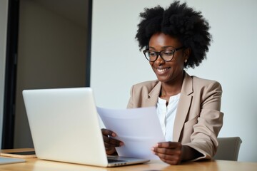 Professional Woman Working on Laptop and Paper Documents in Office Setting, Ideal for Business, Marketing, and Inspirational Content