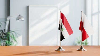 FLAGS OF IRAQ AND POLAND ON TABLE