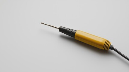 Naklejka premium Yellow and black handheld engraving tool on white background
