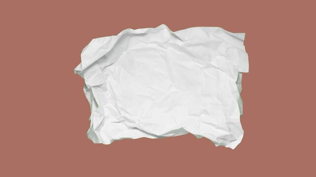 Stop motion animation of crumpled paper on a brown background