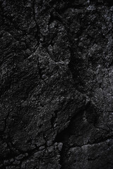 Dark stone texture background. Close up of limestone rock wall. Clay surface with cracks. Modern gray grunge background with space for design. Granite. Slab. Nature Backdrop. Wallpaper. Vertical image