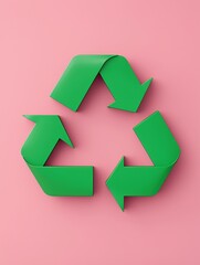 Obraz premium A green recycling symbol made of loops on a pink background, representing sustainability and environmental awareness.