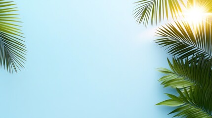 Tropical leaves against a soft blue background with sunlight.