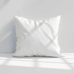 White square pillow on white surface, sunlit.