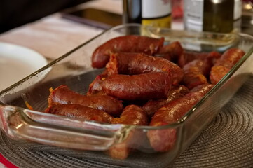 Closeup of sausages in the glass container on the table