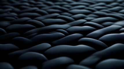 Obraz premium A close-up view of dark, smooth stones arranged in a harmonious pattern, reflecting calmness and nature's beauty.