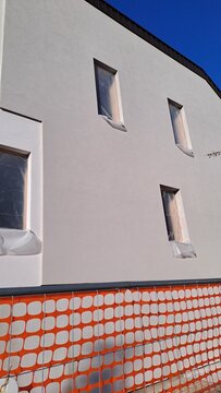 Nuova costruzione di un edificio residenziale in Italia, con rete rossa sul terreno.