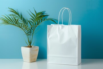 White paper shopping bag next to potted plant.