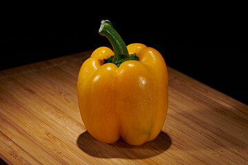 Fresh vegetables for cooking or eating raw photographed against a dark background