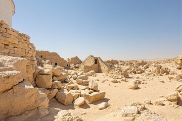 Ancient ruins in a desert landscape under a clear blue sky.