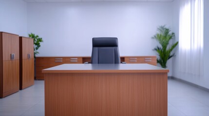 Large wooden desk and black leather chair showing modern executive office