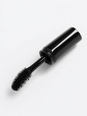 Black mascara tube and wand on white background.