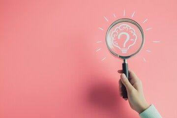
A hand holding a magnifying glass over a simple line drawing of a light bulb and a question mark inside a human head shape on a white background, symbolizing creativity and the thinking process.