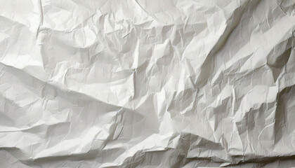 Fototapeta premium Crumpled White Paper,A crumpled sheet of white paper with various folds and creases.