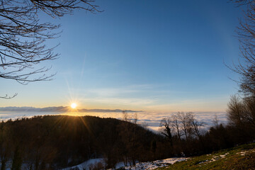 Sunset over a mountain above the sea of fog with blue sky in the golden hour in Vorarlberg Austria